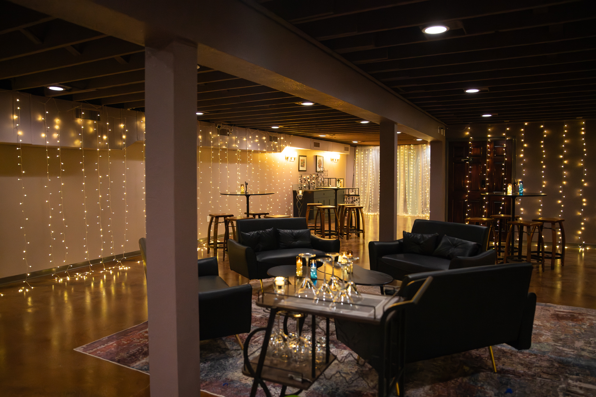 Cellar at NYX with lounge seating, cocktail tables, and warm string lighting.
