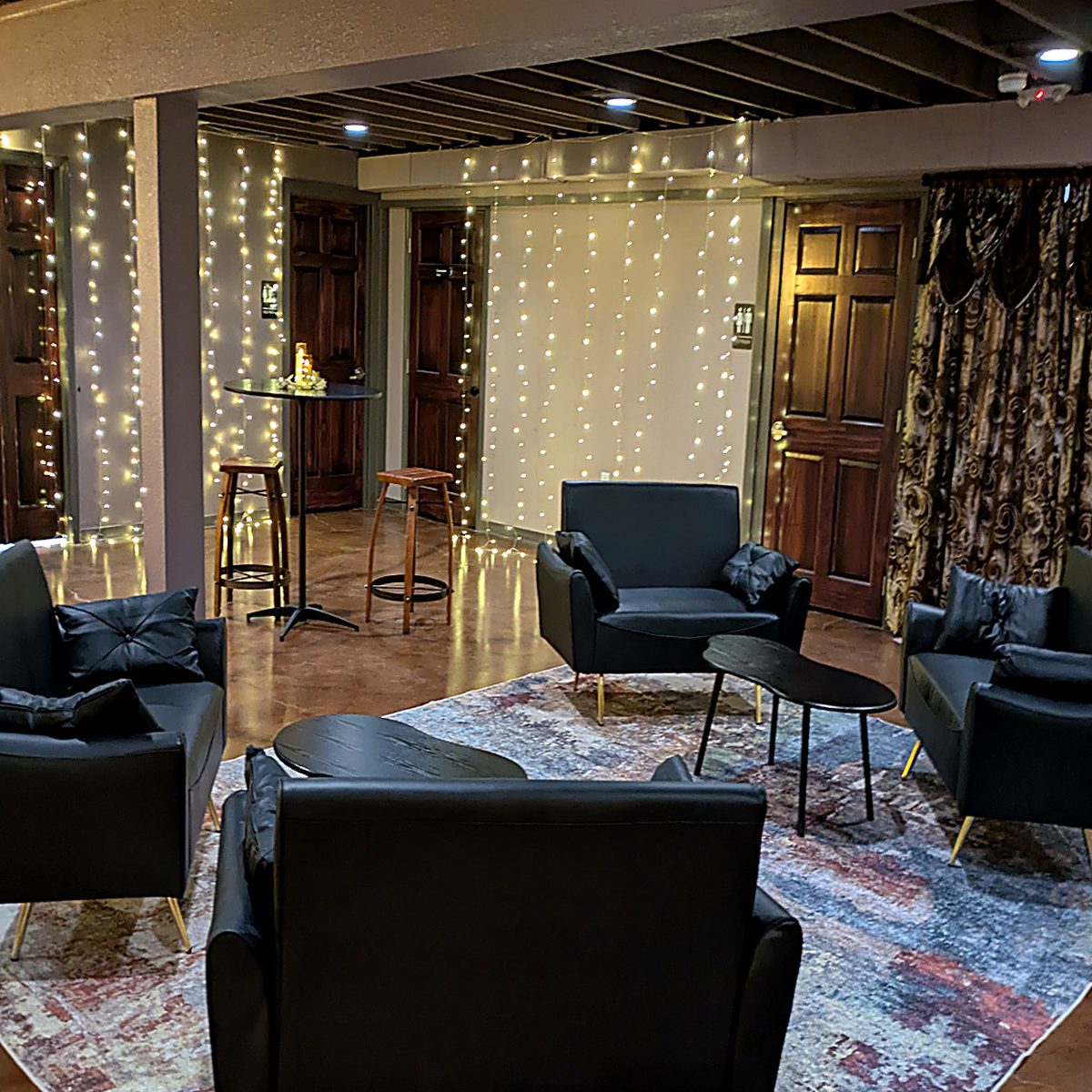 Downstairs lounge seating at NYX Spirits & Lounge with soft lighting and comfortable chairs.